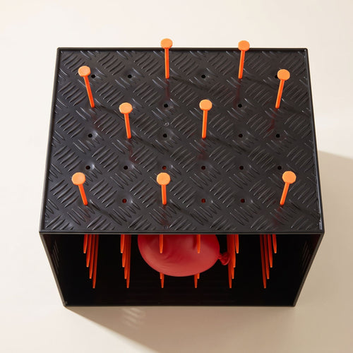 The LastPops game box from above with orange plastic nails in the top and the balloon visible at the side