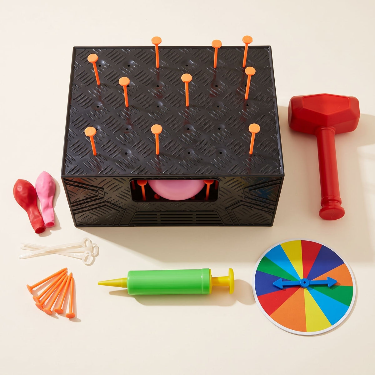 The LastPops kit laid out on a table: box, hammer, hand pump, ties, spare balloons, nails and spinner
